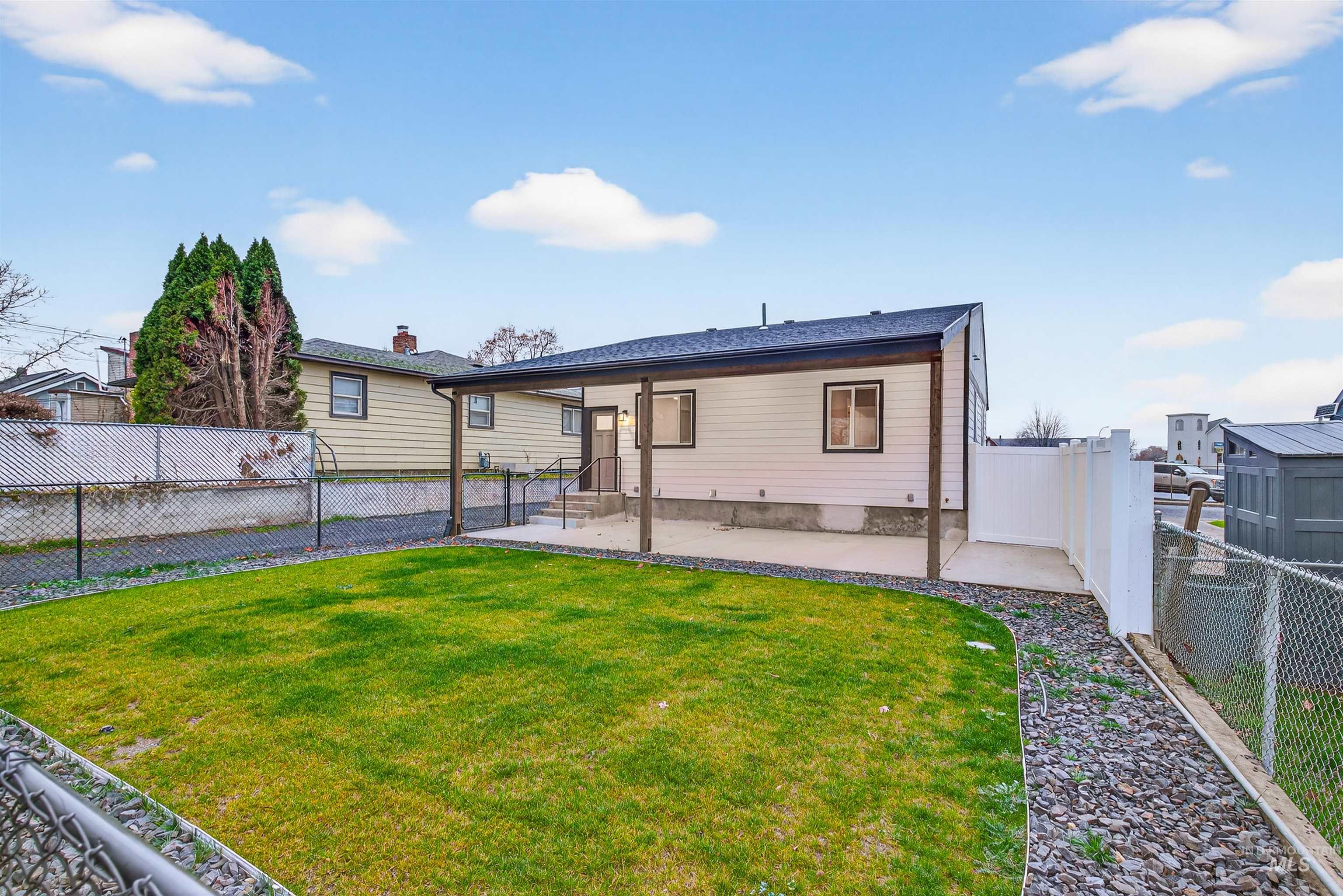 929 10th Street Clarkston, WA 99403 - Photo 36 of 43 Rear view of property with a patio area and a fenced backyard