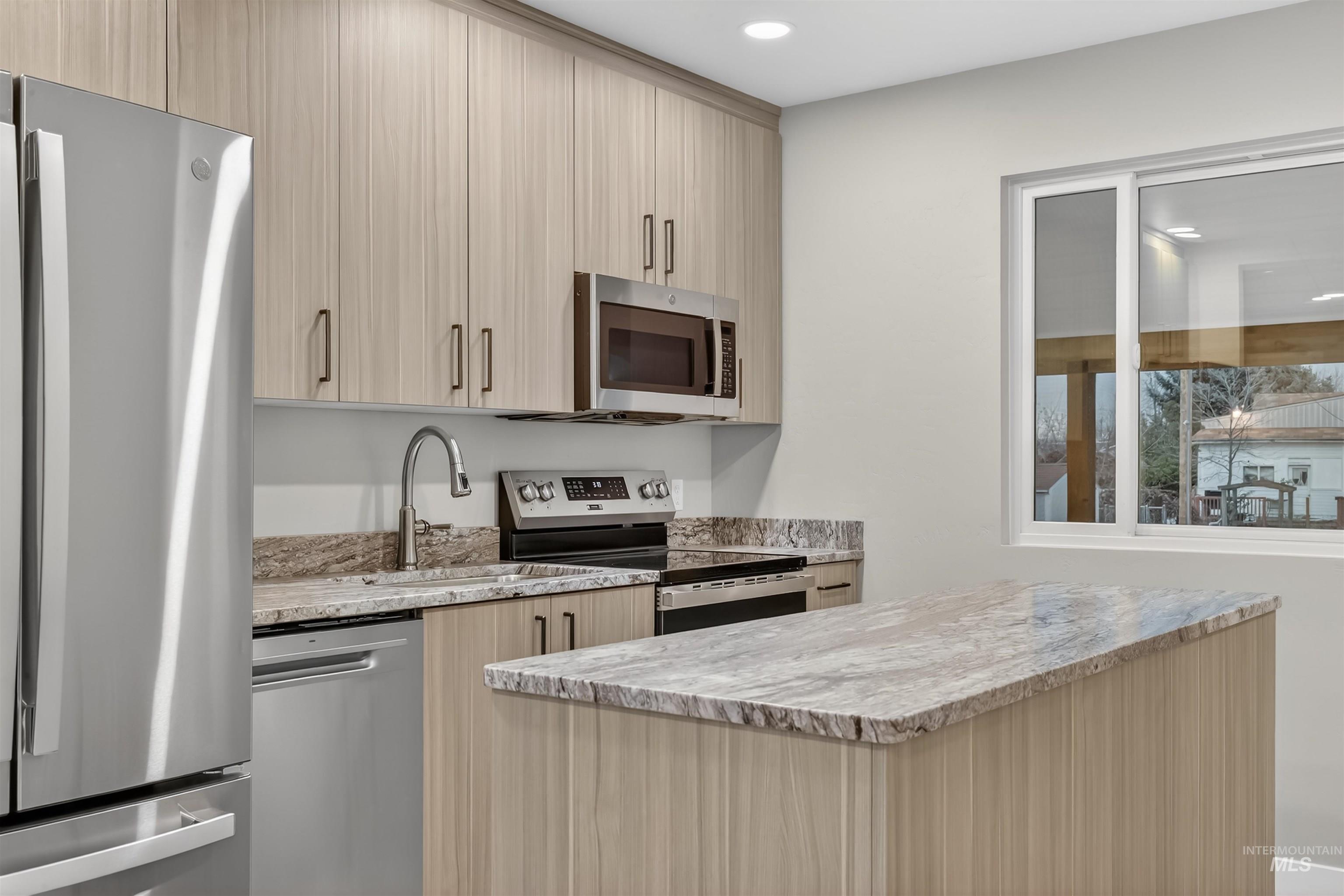 929 10th Street Clarkston, WA 99403 - Photo 9 of 43 Kitchen featuring stainless steel appliances, light brown cabinets, light stone counters, modern cabinets, and recessed lighting