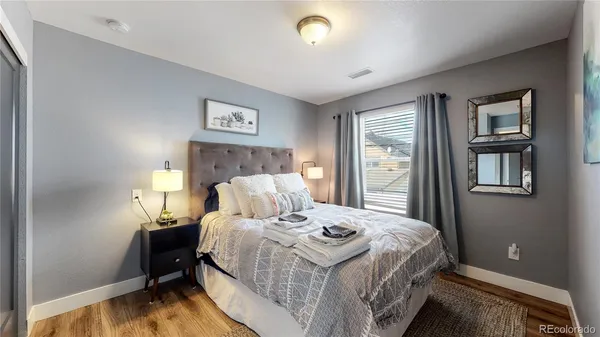 a bedroom with a bed and a night stand