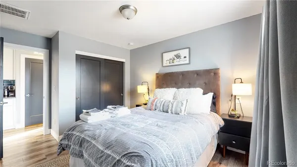 a bedroom with a bed and a mirror