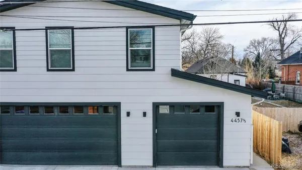 a front view of a house with a glass door and shower