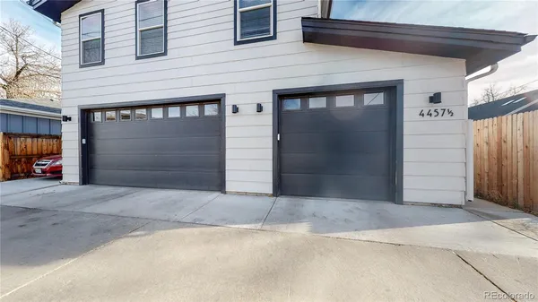 a front view of a house with parking garage and garage