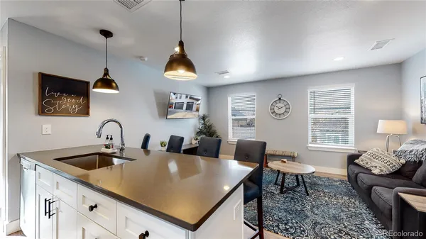 a kitchen with a dining table chairs sink and cabinets