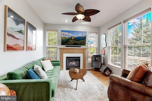 a living room with furniture a flat screen tv and a fireplace