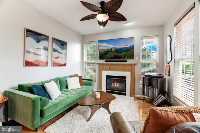 a living room with furniture a flat screen tv and a fireplace