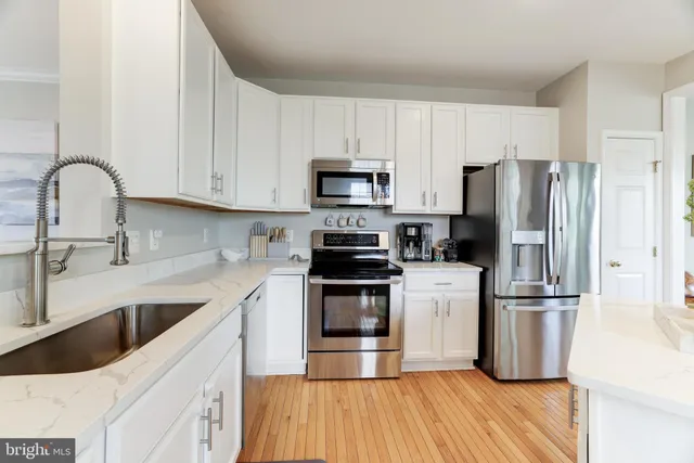 a kitchen with a sink cabinets and stainless steel appliances