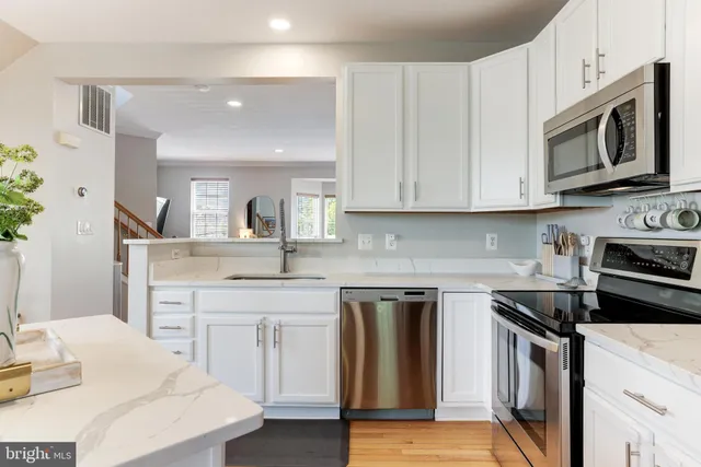 a kitchen with a sink stove and microwave