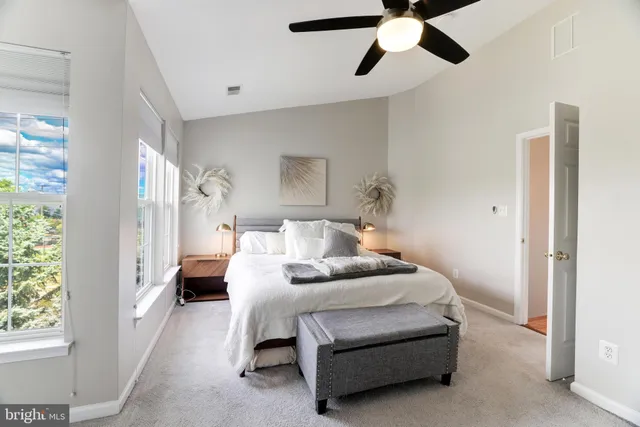 a bedroom with bed and a chandelier