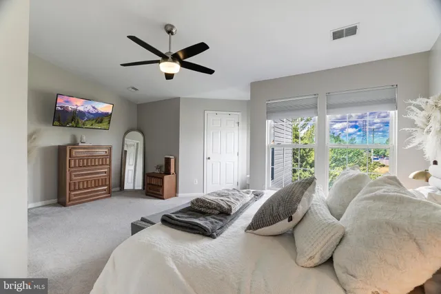 a bedroom with a bed dresser and a window