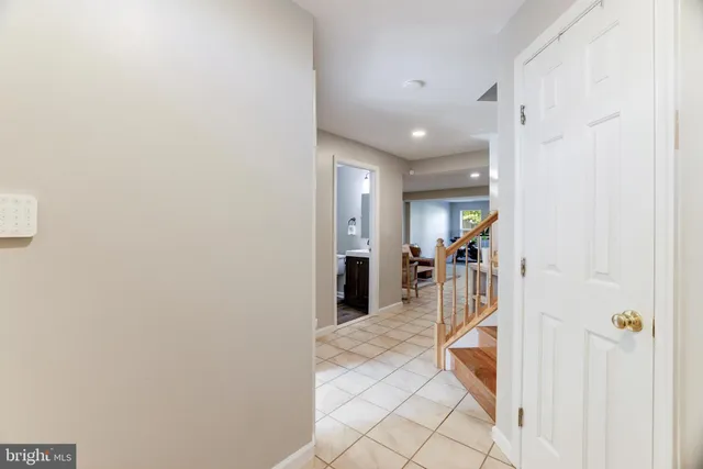 a view of a hallway with a furniture and a bathroom