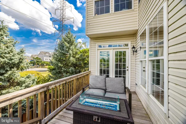a view of a balcony with wooden floor and fence