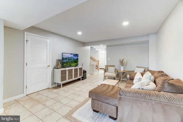 a living room with furniture a couch and a flat screen tv