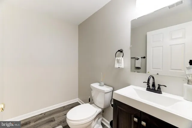 a bathroom with a sink a toilet and mirror