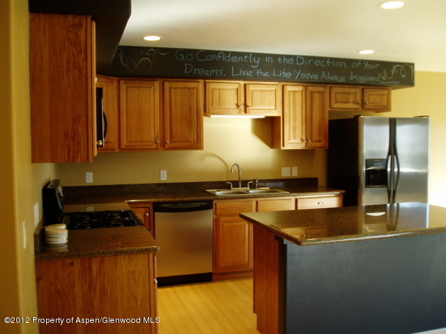 668 Alder Ridge Lane New Castle, CO 81647 - Photo 1 of 30 a kitchen with a sink and a refrigerator