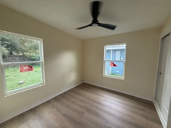 wooden floor in an empty room with a window