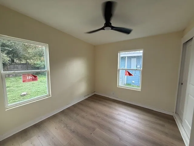 wooden floor in an empty room with a window