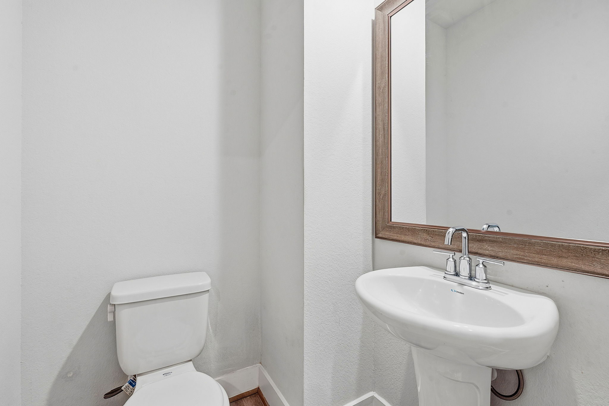 7105 Silver Star Lane, Unit 59 Austin, TX 78744 - Photo 8 of 19 a bathroom with a sink a toilet and mirror