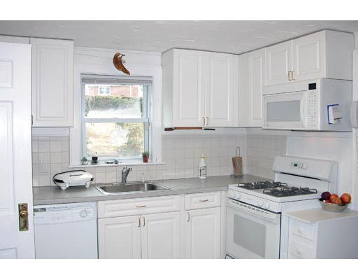 25 Oakmont Road Newton, MA 02459 - Photo 3 of 3 a kitchen with stainless steel appliances granite countertop a sink a stove a microwave a counter space and cabinets