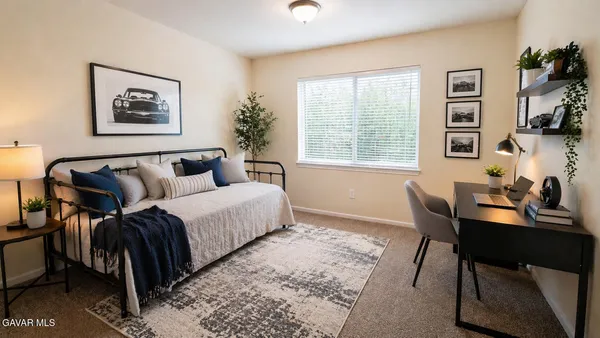 a bedroom with a bed and a desk