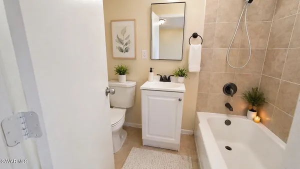 a bathroom with a white sink a toilet and a bathtub