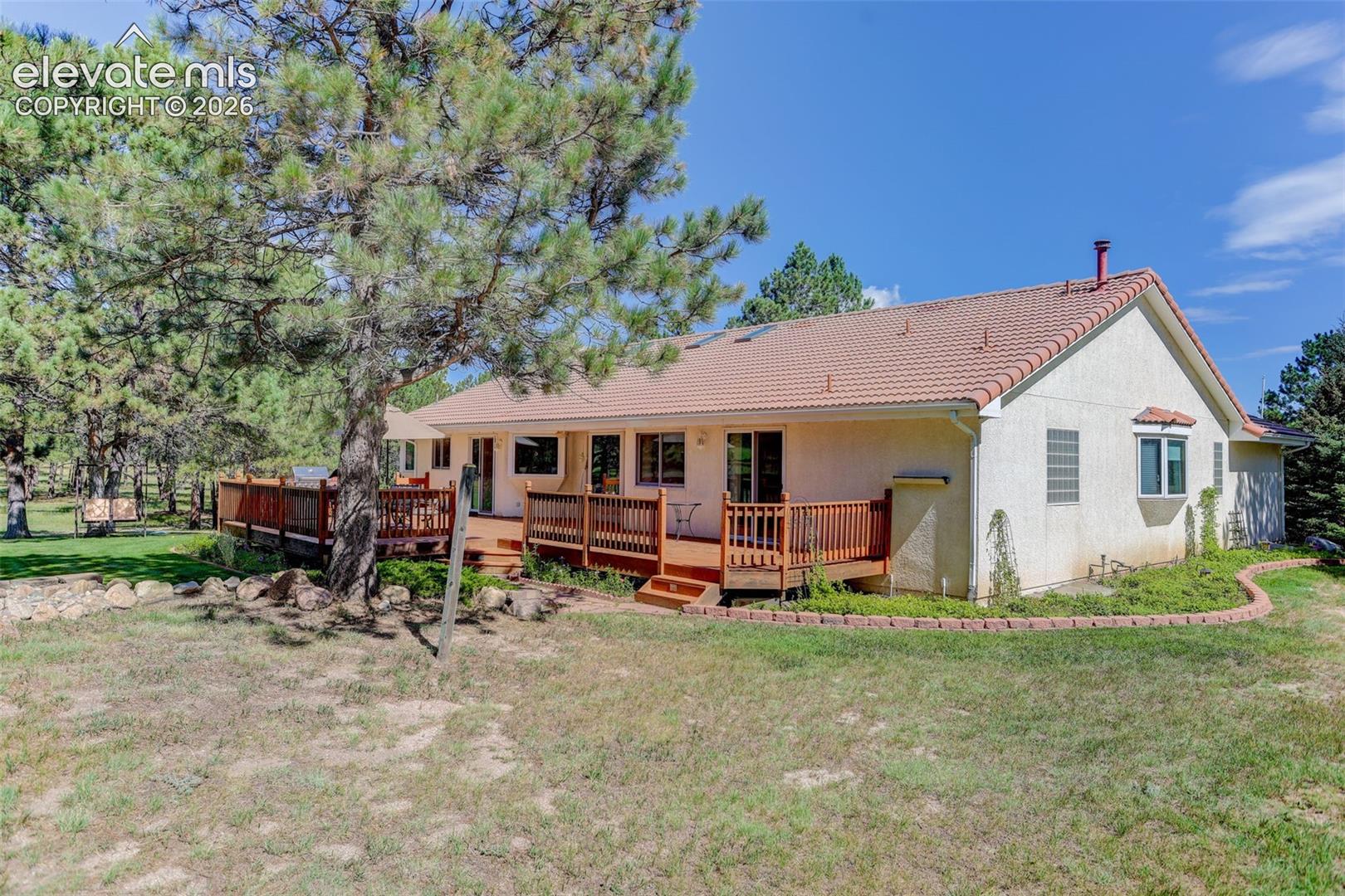 Back and side of structure. Back deck and garden along home. 