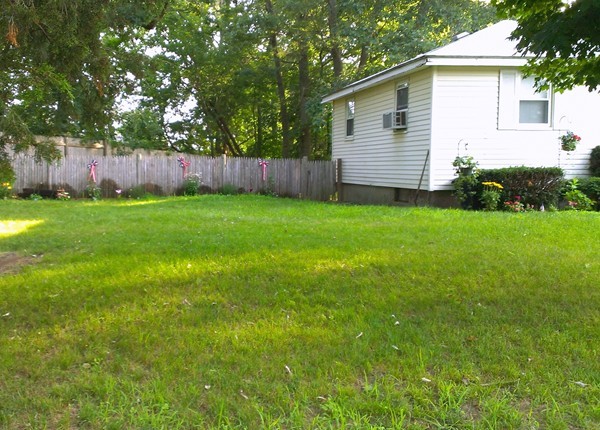 67 Rhodes Circle Hingham, MA 02043 - Photo 2 of 12 a view of a backyard with a garden
