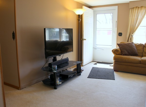 67 Rhodes Circle Hingham, MA 02043 - Photo 6 of 12 a living room with furniture and a flat screen tv