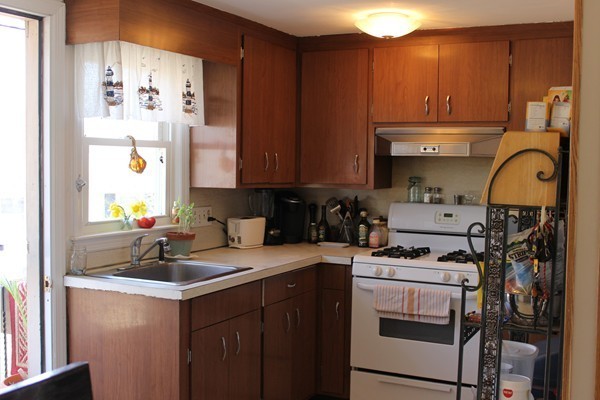 67 Rhodes Circle Hingham, MA 02043 - Photo 7 of 12 a kitchen with a sink cabinets and appliances