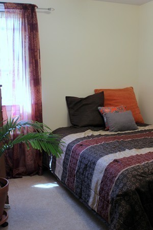 67 Rhodes Circle Hingham, MA 02043 - Photo 10 of 12 a bedroom with a bed lamp and a potted plant