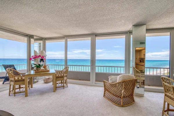 a living room with furniture and a floor to ceiling window
