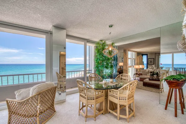 a dining room with furniture and a large window