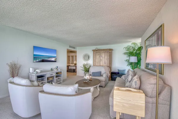 a living room with furniture and a lamp