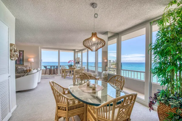 a dining room with furniture a chandelier and window