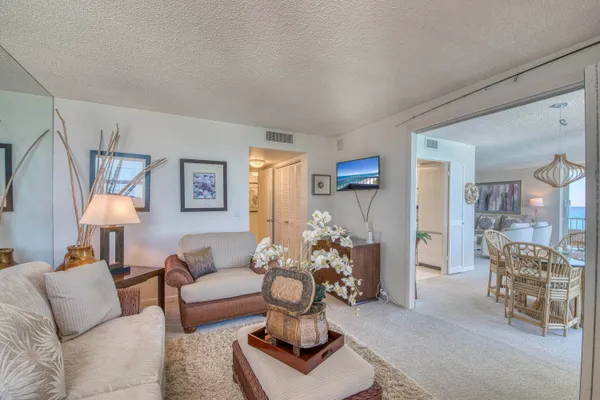 a living room with furniture and a chandelier