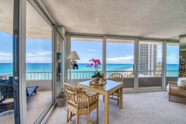 a dining room with furniture and front door