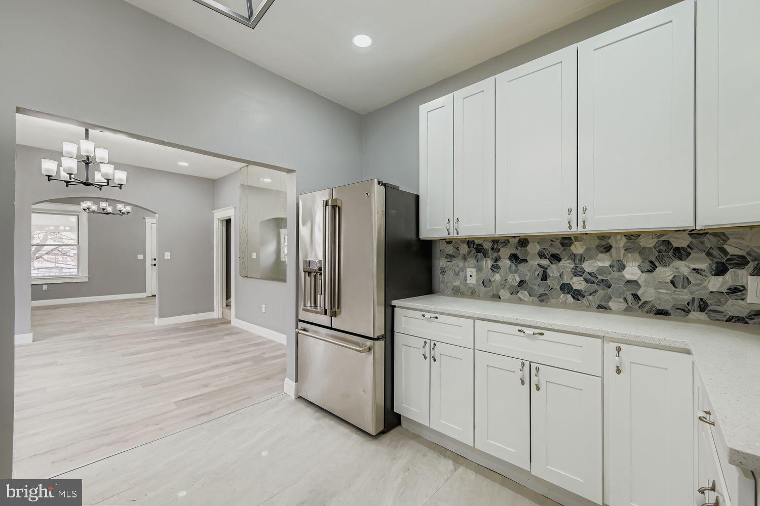 4111 Penhurst Avenue Baltimore, MD 21215 - Photo 13 of 39 a kitchen with granite countertop white cabinets and stainless steel appliances
