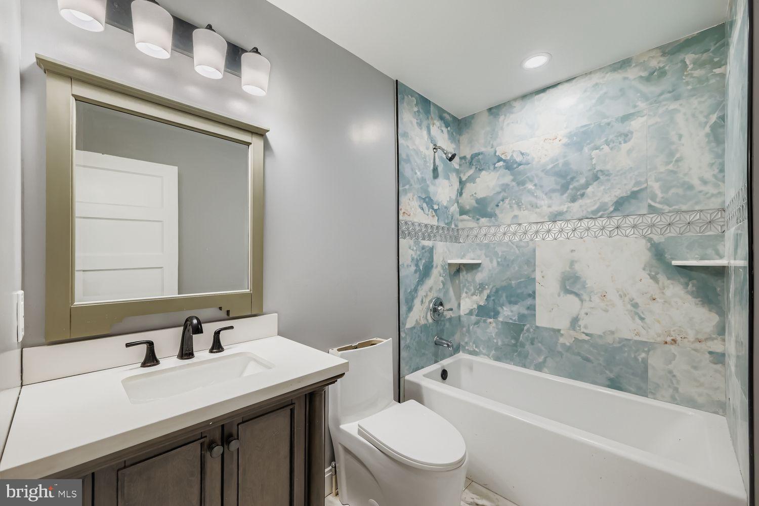 4111 Penhurst Avenue Baltimore, MD 21215 - Photo 18 of 39 a bathroom with a granite countertop sink toilet and shower