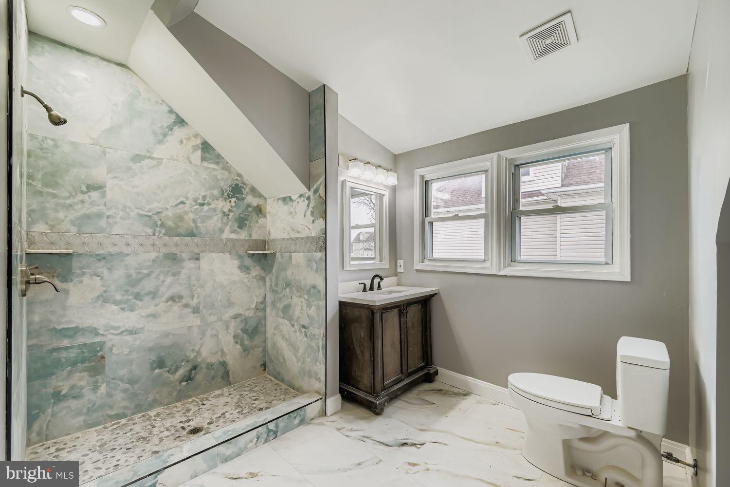 4111 Penhurst Avenue Baltimore, MD 21215 - Photo 22 of 39 a bathroom with a sink mirror vanity and toilet