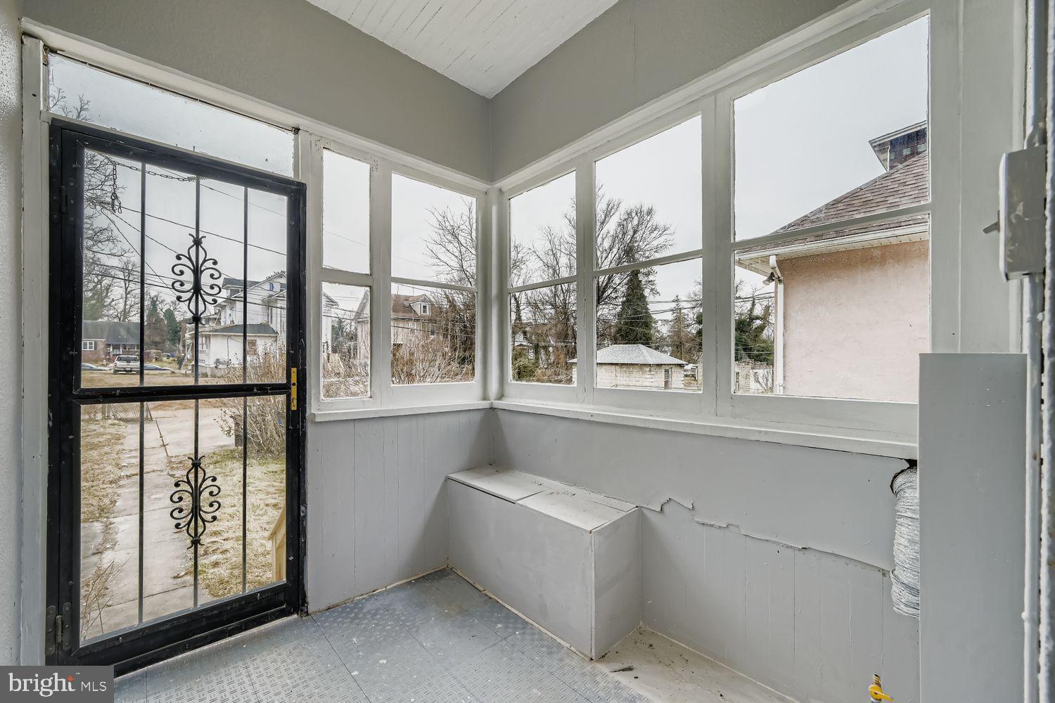 4111 Penhurst Avenue Baltimore, MD 21215 - Photo 34 of 39 a bathroom with a large window and mirror