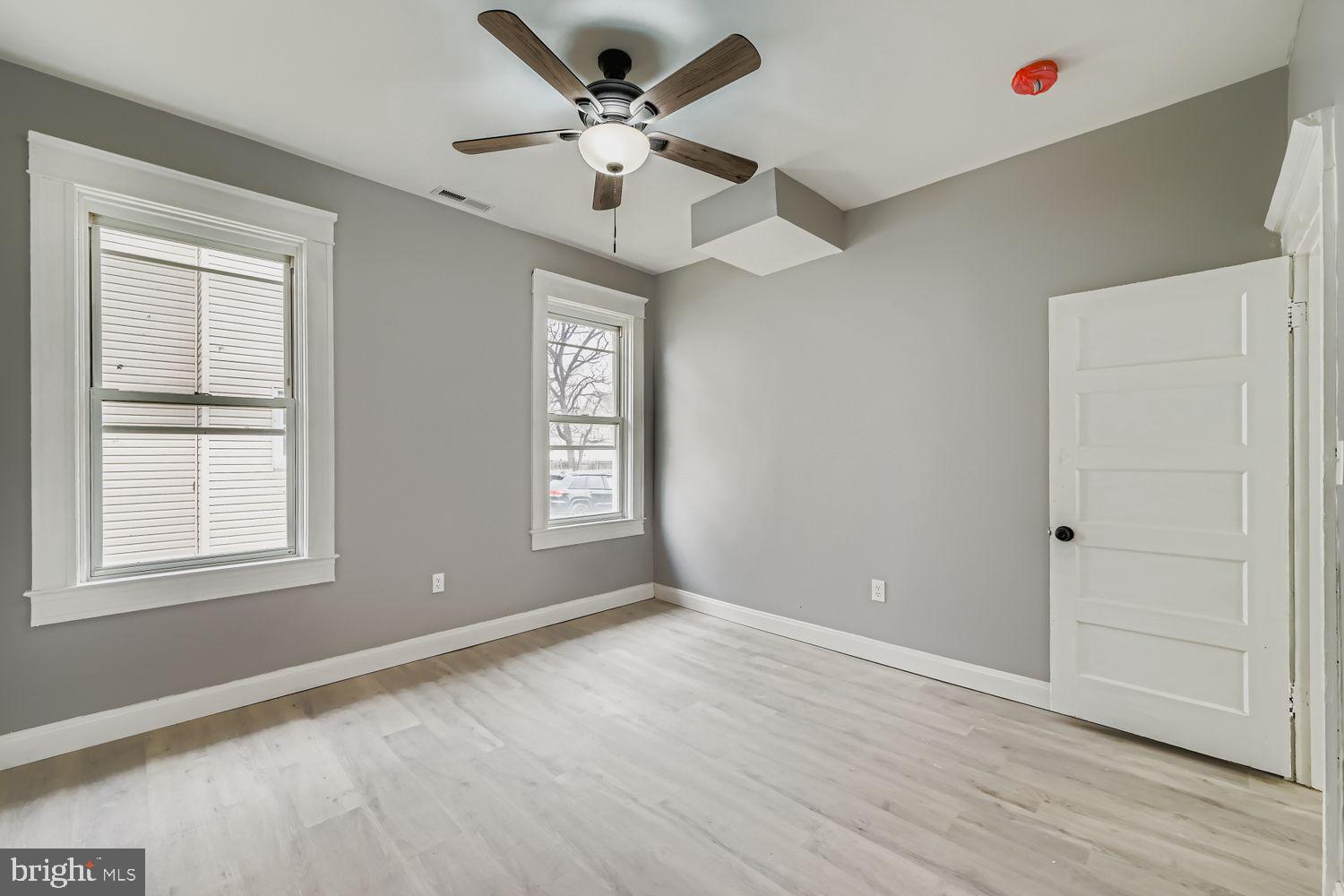 4111 Penhurst Avenue Baltimore, MD 21215 - Photo 6 of 39 a view of an empty room with a window and wooden floor