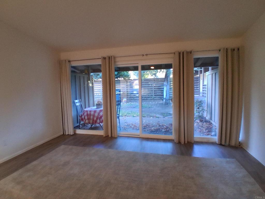 28857 Old Highway 80, Unit 14 Pine Valley, CA 91962 - Photo 5 of 12 an empty room with windows wooden wall and door