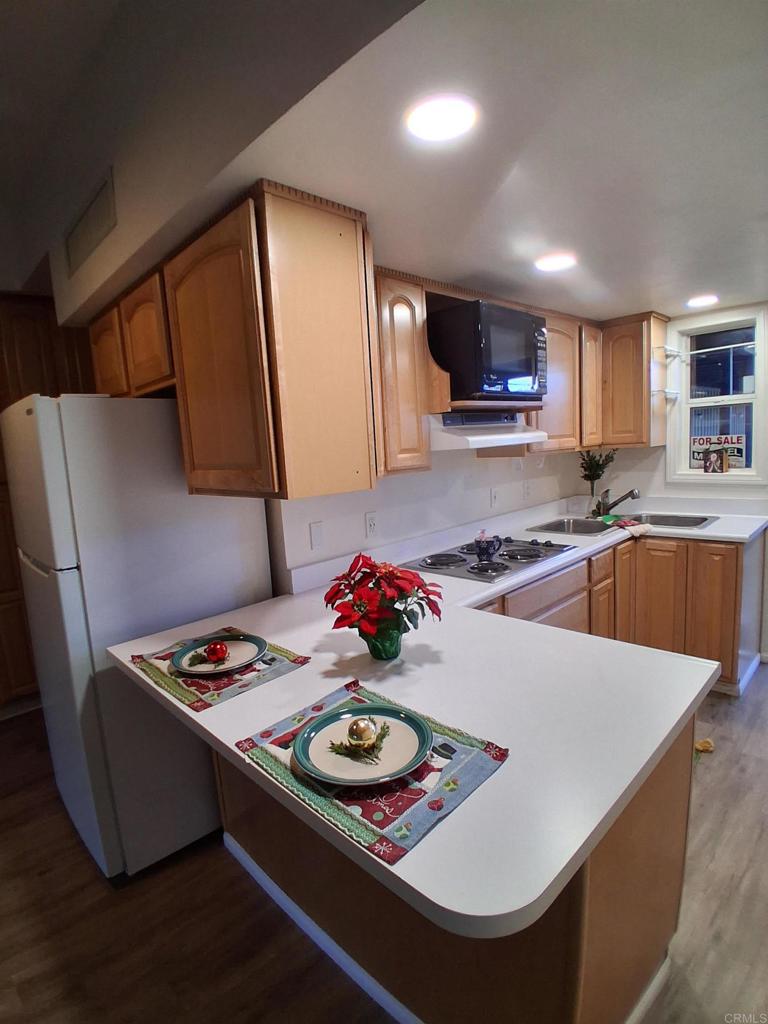 28857 Old Highway 80, Unit 14 Pine Valley, CA 91962 - Photo 6 of 12 a kitchen with stainless steel appliances granite countertop a sink a stove and a refrigerator