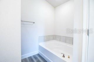 1791 Roberts Trail Bell, FL 32619 - Photo 11 of 28 a white bath tub sitting in a bathroom