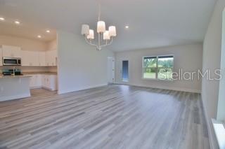 1791 Roberts Trail Bell, FL 32619 - Photo 15 of 28 a view of a room with wooden floors and chandelier