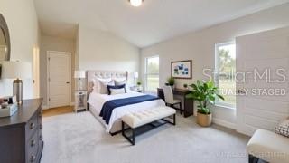 1791 Roberts Trail Bell, FL 32619 - Photo 24 of 28 a bed room with a bed and a potted plant