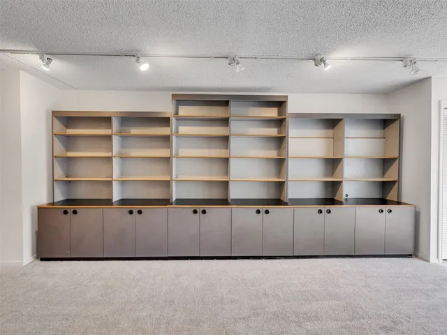 a view of an empty room with shelves