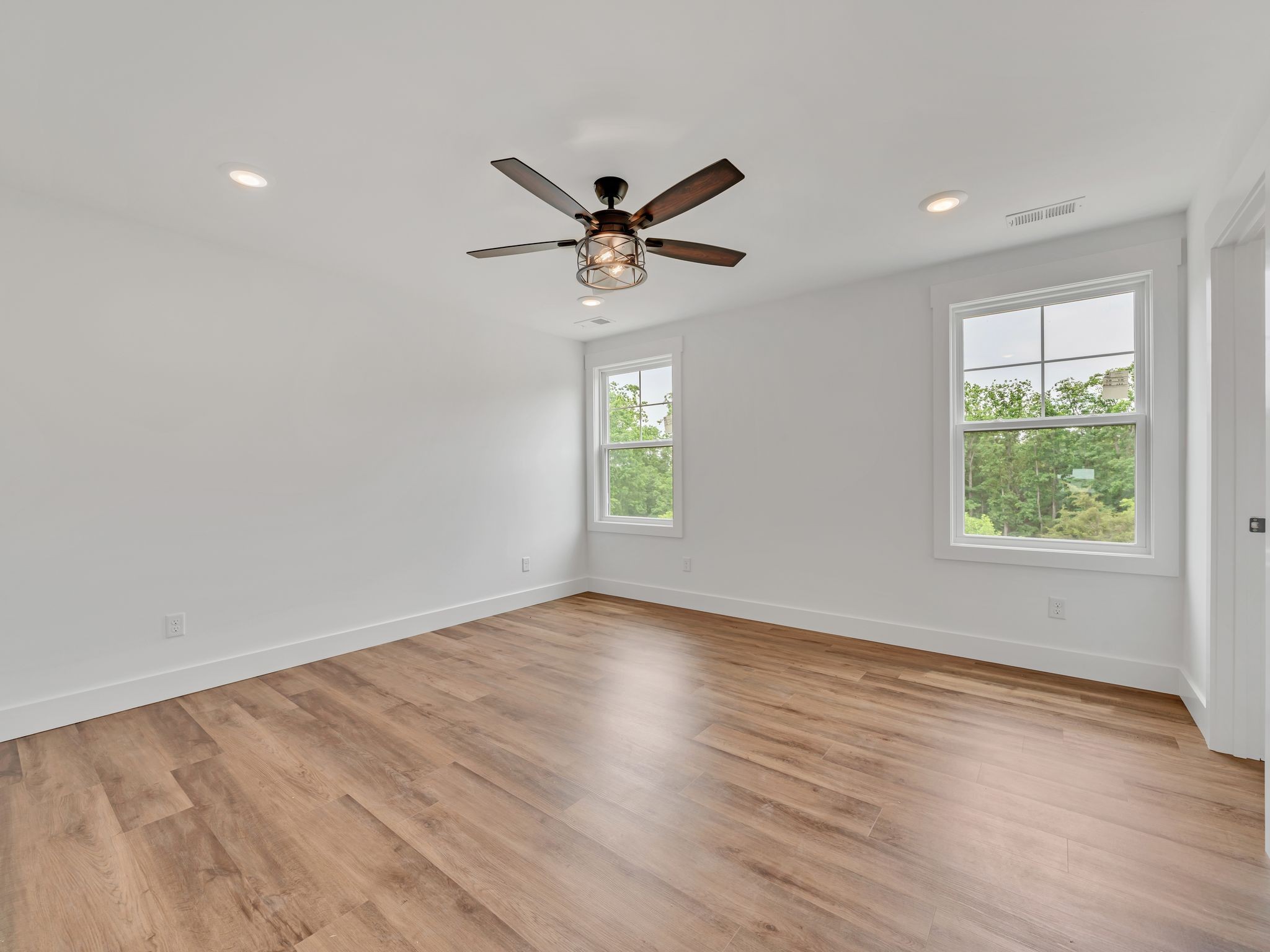 5800 Sanders Road Lyles, TN 37098 - Photo 22 of 28 an empty room with wooden floor ceiling fan and windows