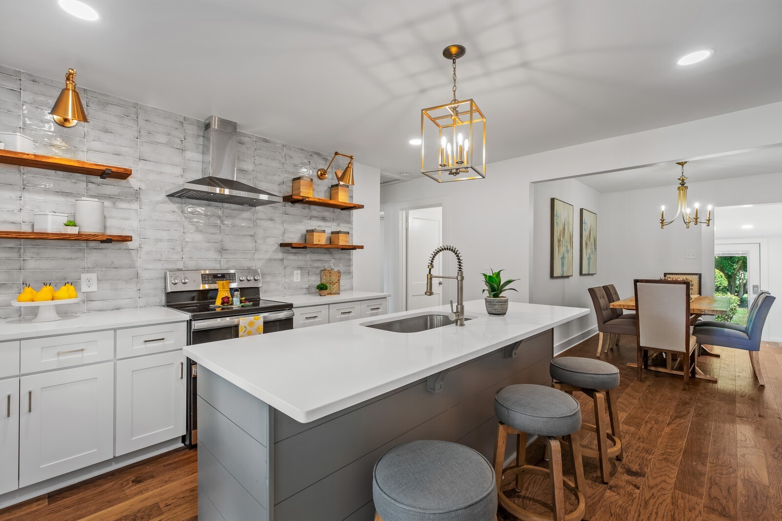 4911 Log Cabin Road Nashville, TN 37216 - Photo 1 of 10 a kitchen that has a lot of cabinets a stove and wooden floor