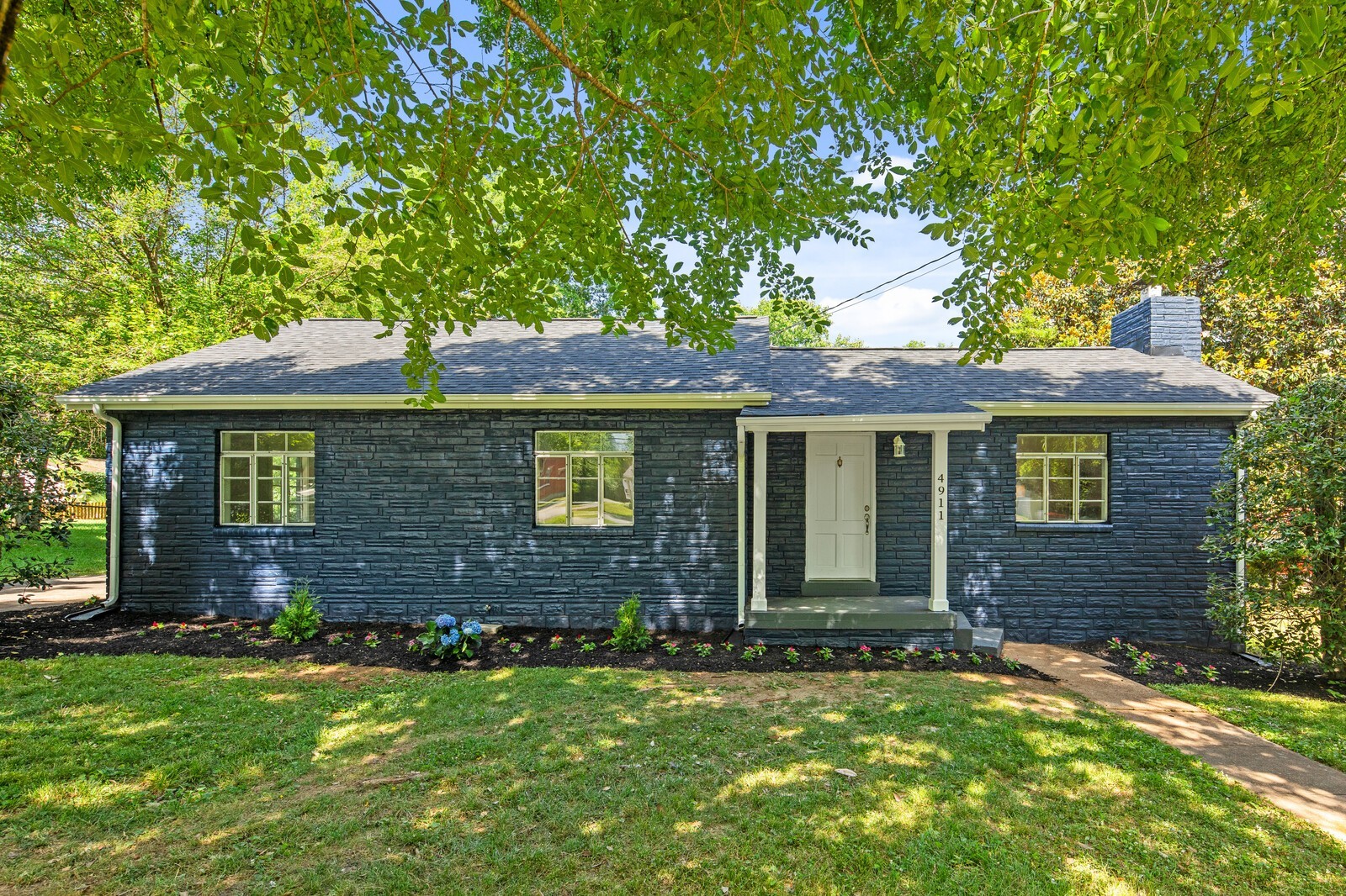 4911 Log Cabin Road Nashville, TN 37216 - Photo 2 of 10 front view of a house with a garden