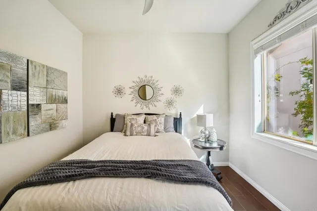 a bedroom with a bed and a window